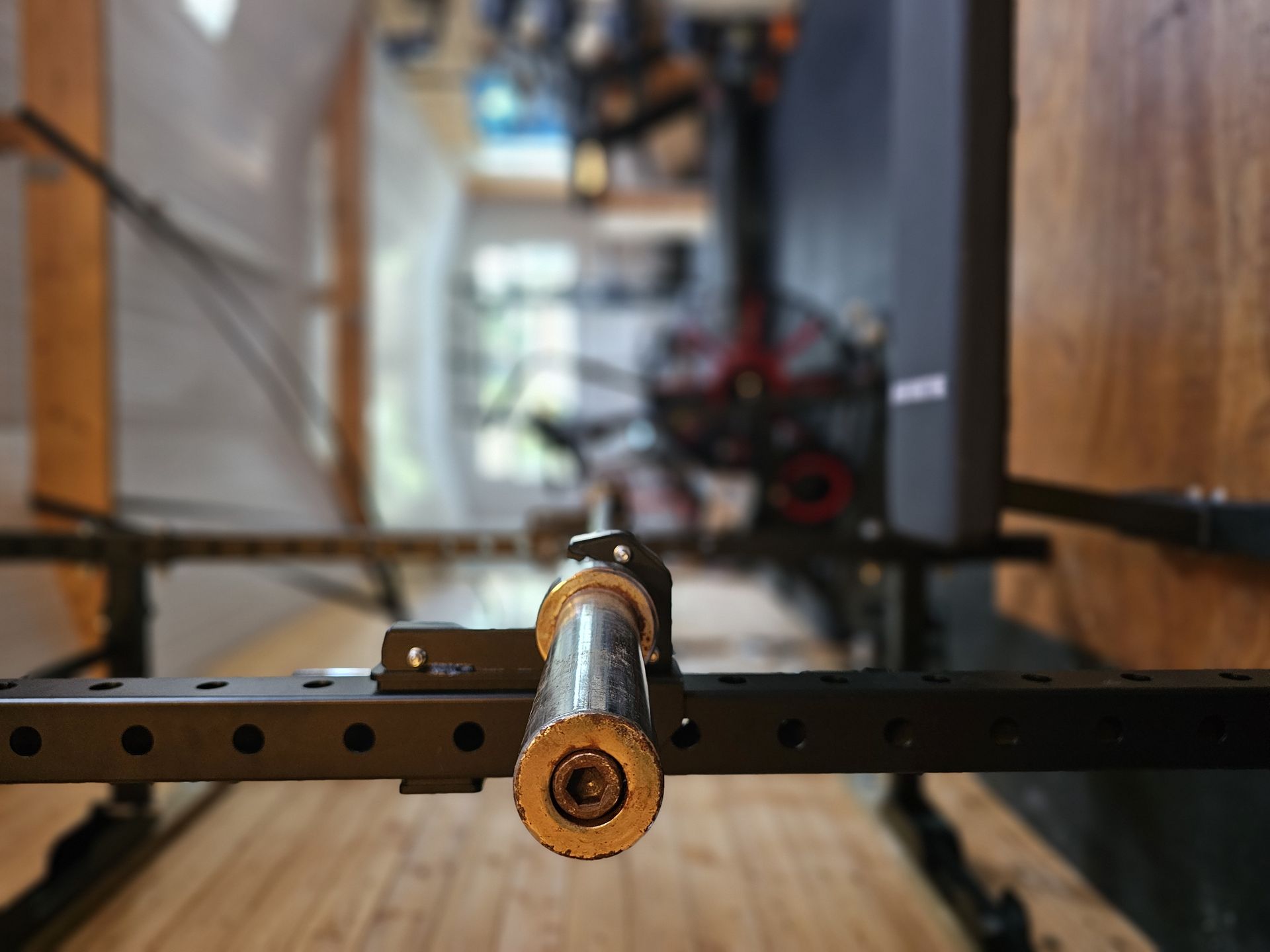 Squat rack J-cup with the studio floor behind