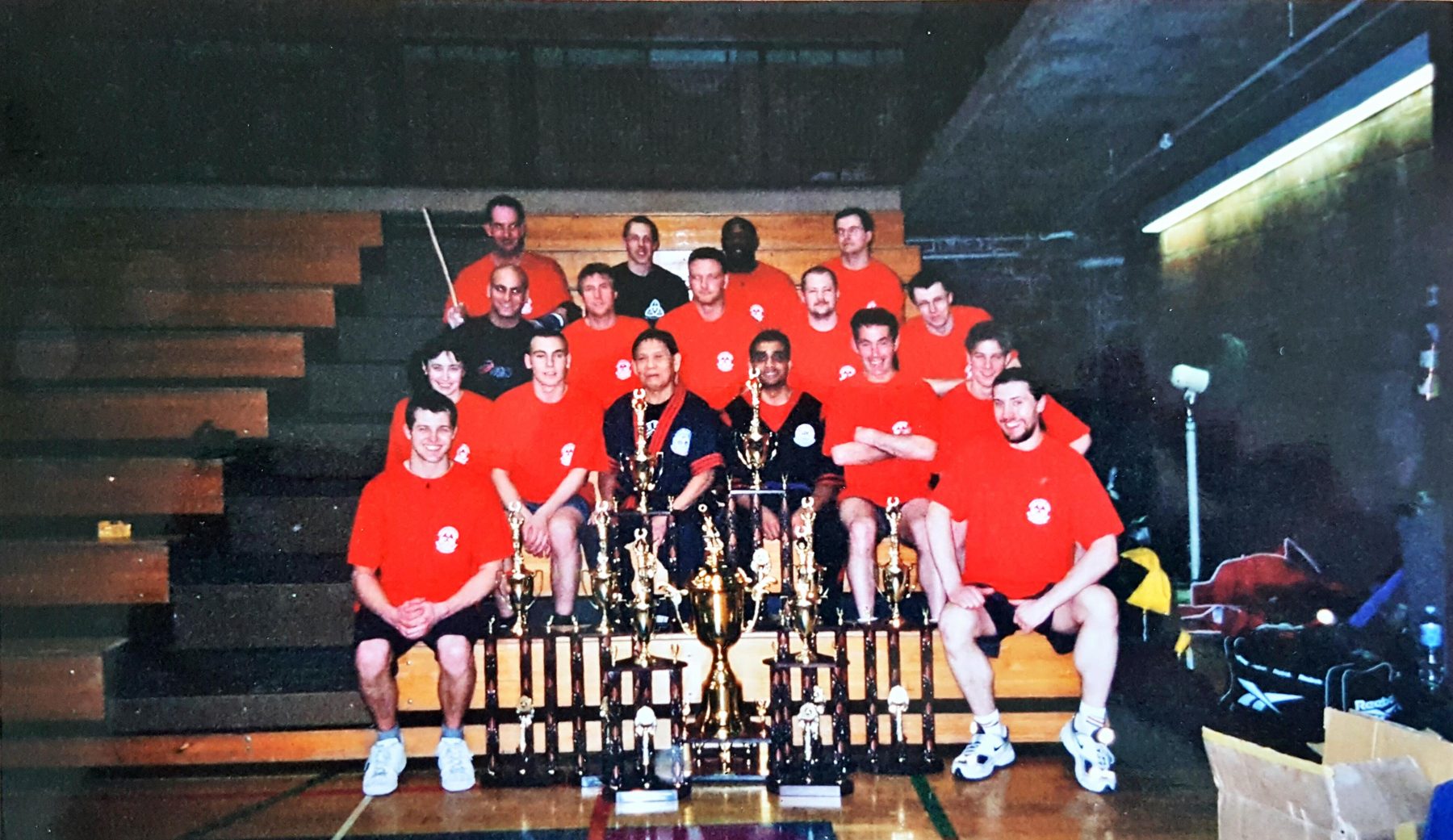 Stick-fighting team with championship trophies